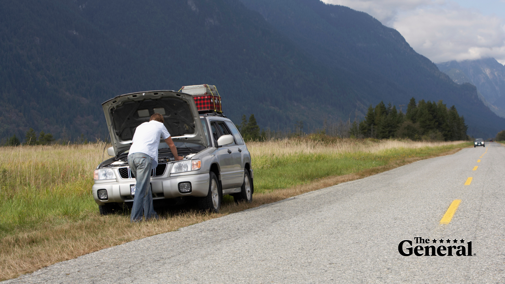 Man inspecting his car, under the hood, trying to figure out why his car won't start. 5 Reasons Why Your Car Won't Start